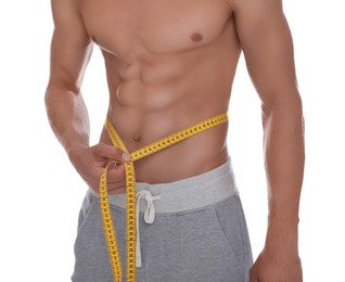Photo of Shirtless man with slim body and measuring tape around his waist isolated on white, closeup