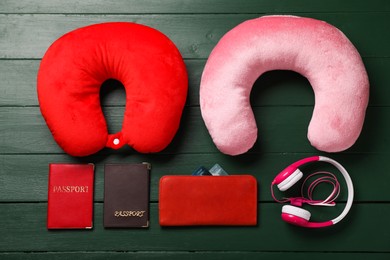 Photo of Flat lay composition with colorful travel pillows on green wooden background