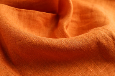 Photo of Texture of beautiful orange fabric as background, closeup