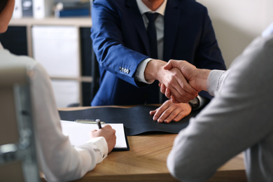 Male lawyer working with clients in office, closeup