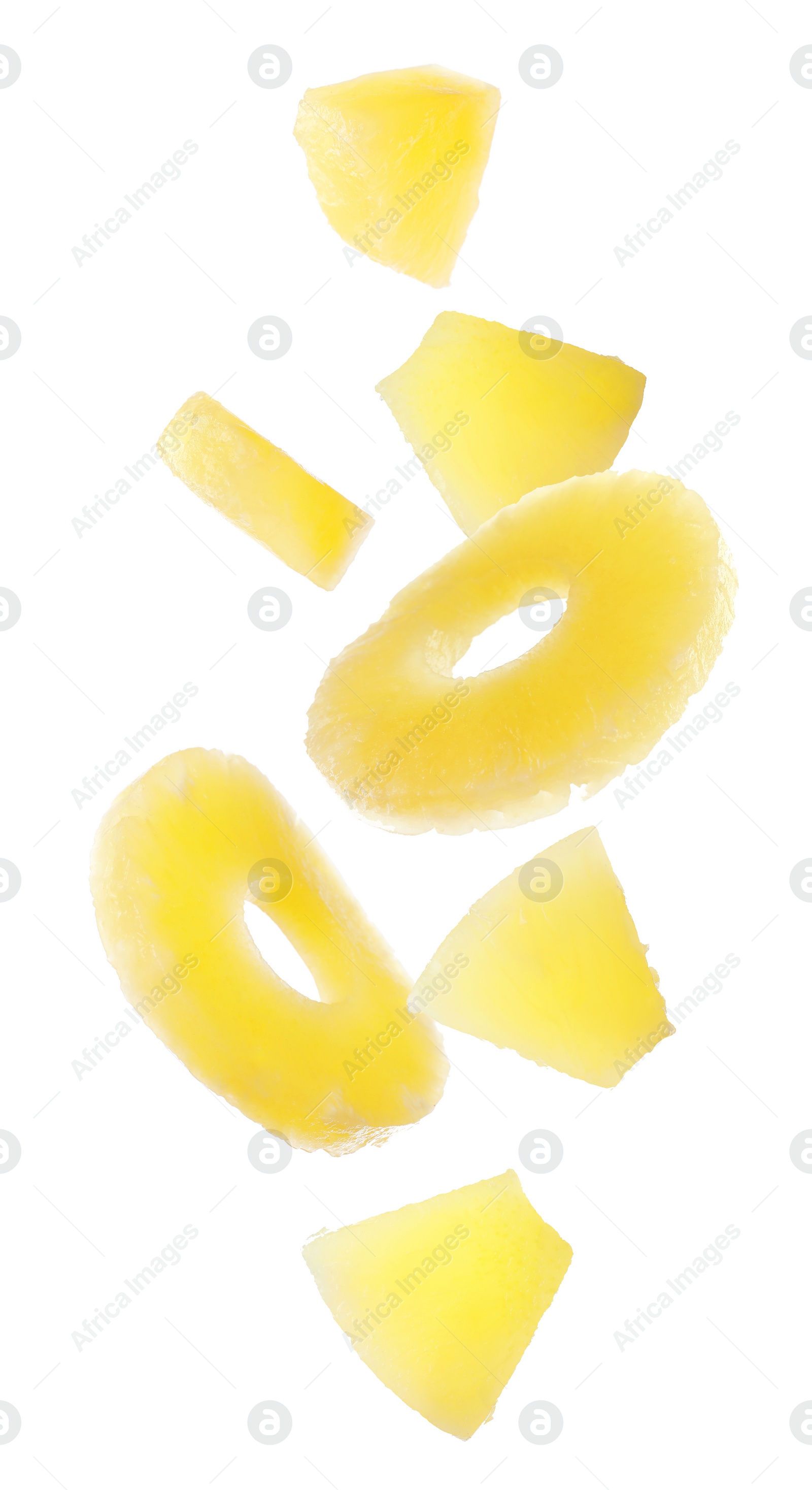 Image of Canned pineapple rings and pieces falling on white background