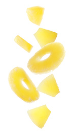 Image of Canned pineapple rings and pieces falling on white background