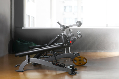 Photo of Abdominal bench in gym. Modern sport equipment
