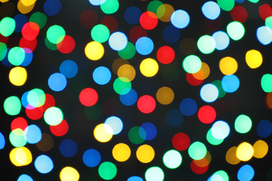 Photo of Multicolor blurred lights on black background. Bokeh effect