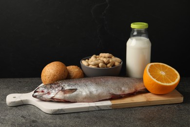 Photo of Allergenic food. Different fresh products on gray table against dark background