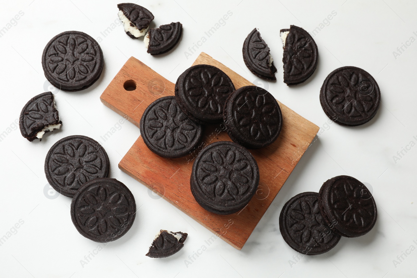 Photo of Tasty sandwich cookies on white table, flat lay