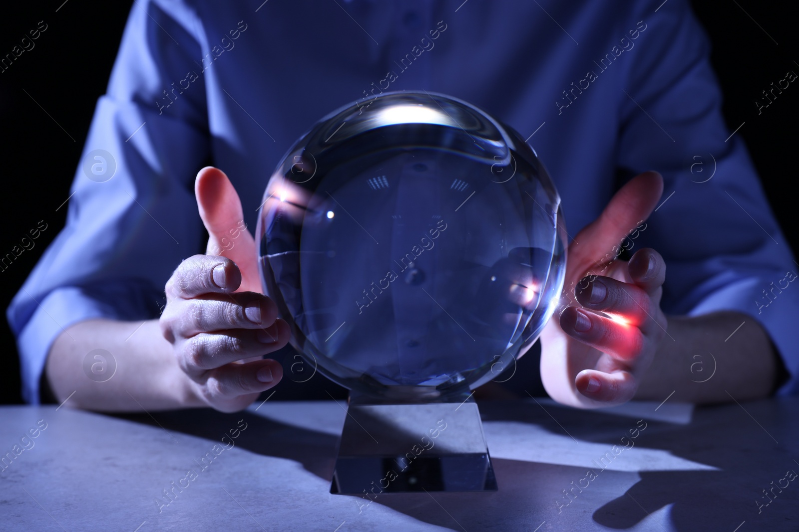 Photo of Businesswoman using ball to predict future at table, closeup