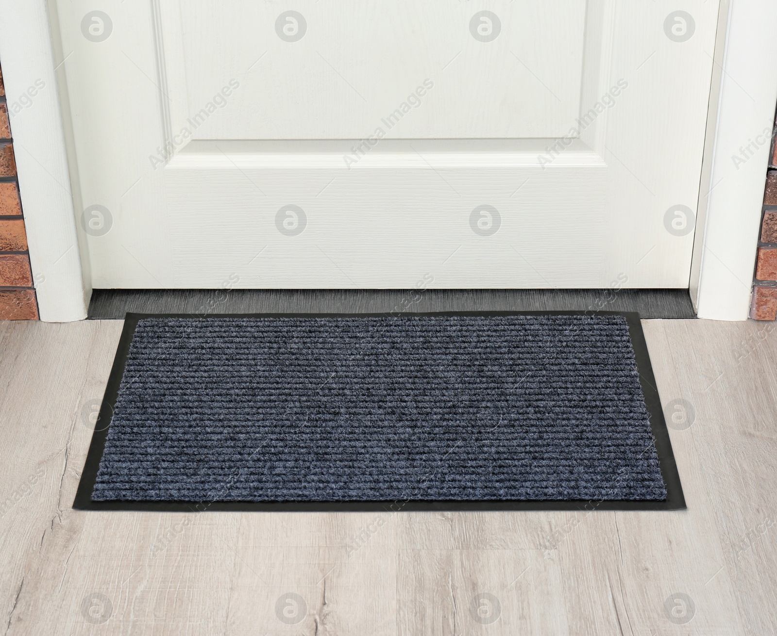 Photo of New clean mat near entrance door. Household item