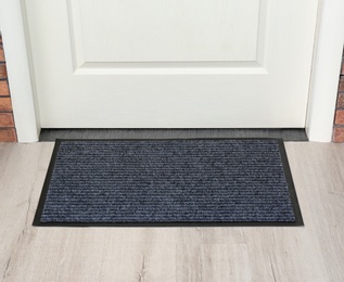 Photo of New clean mat near entrance door. Household item