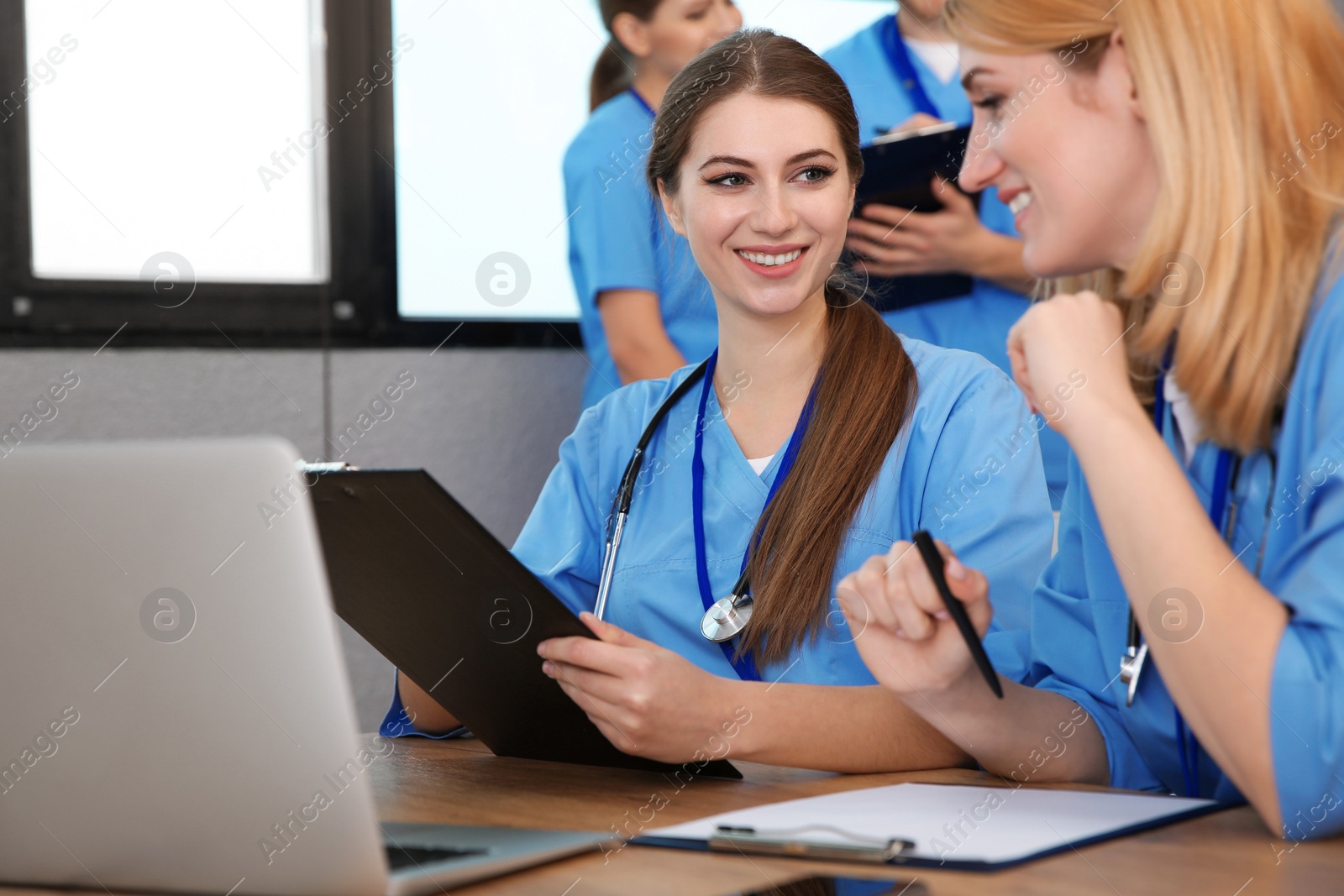 Photo of Medical students in uniforms studying at university