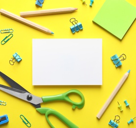 Flat lay composition with scissors and office supplies on color background. Space for text