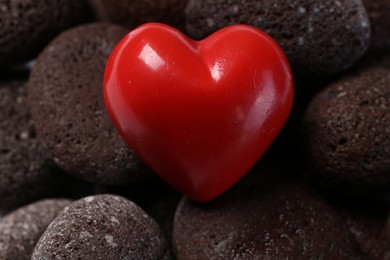 Red decorative heart on stones, closeup view