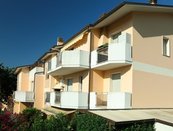 Photo of Modern residential building with balconies on sunny day