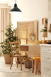 Photo of Modern kitchen interior with wooden crates as eco furniture