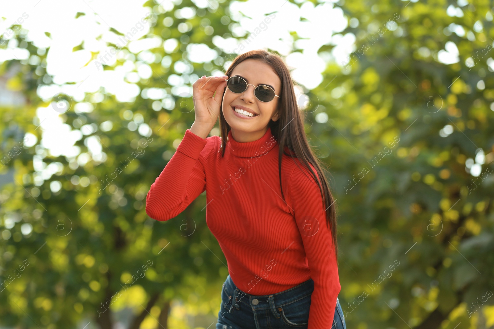 Photo of Beautiful woman wearing stylish sunglasses in green park