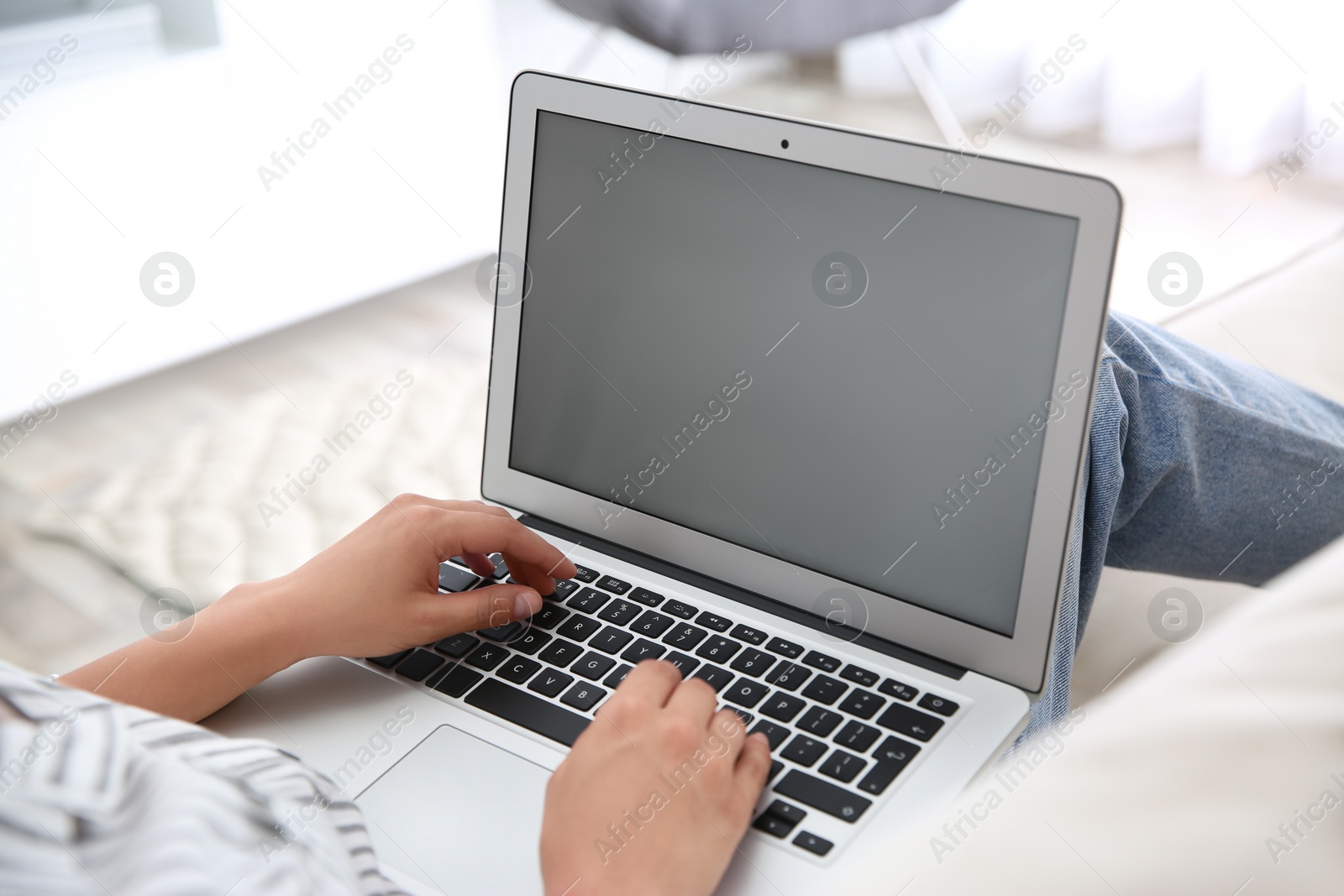 Photo of Woman working with modern laptop indoors, closeup. Space for design