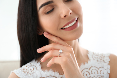 Young bride wearing beautiful engagement ring, closeup