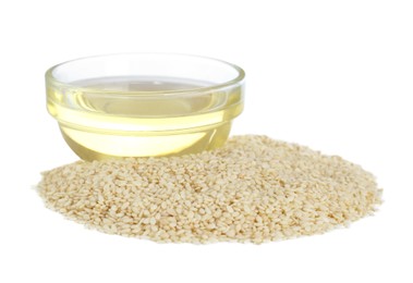 Photo of Glass bowl of fresh sesame oil and seeds isolated on white