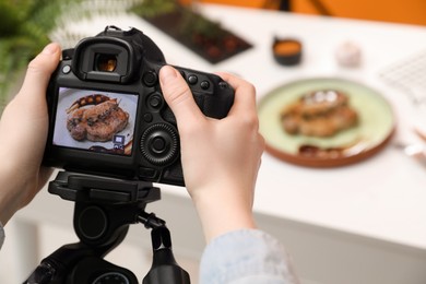 Photo of Food stylist taking photo of delicious meat medallion in studio, closeup. Space for text