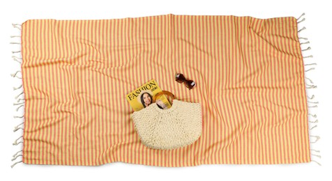 Photo of Striped beach towel with bag, magazine and sunglasses on white background, top view