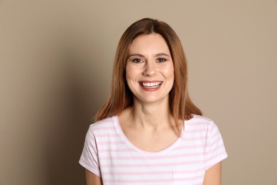 Photo of Smiling woman with perfect teeth on color background