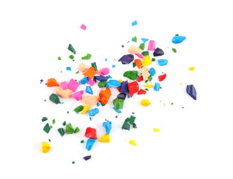 Photo of Colorful graphite crumbs on white background, top view. Pencil sharpening