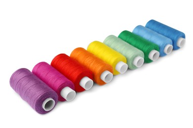 Photo of Set of different colorful sewing threads on white background