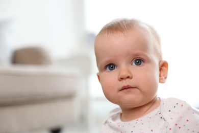 Photo of Portrait of cute baby girl in room. Space for text