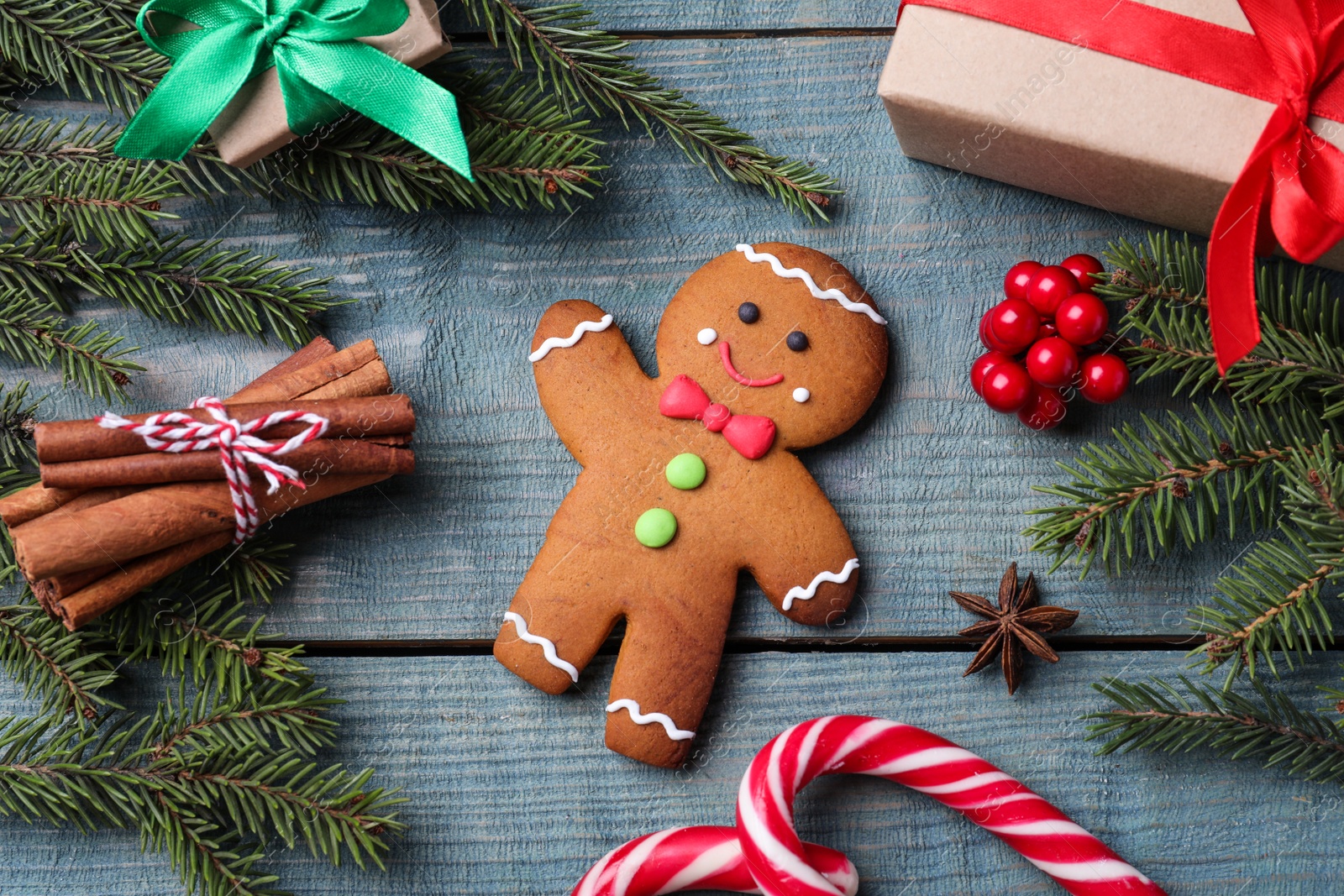 Photo of Flat lay composition with gingerbread man on blue wooden table