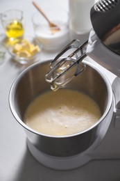 Photo of Making dough in bowl of stand mixer on white table