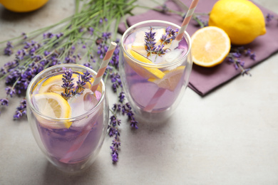 Photo of Fresh delicious lemonade with lavender on grey table