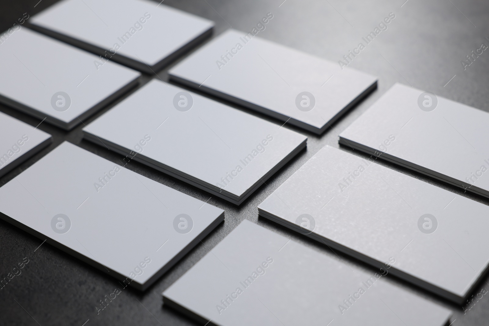 Photo of Blank business cards on grey textured table, closeup. Mockup for design