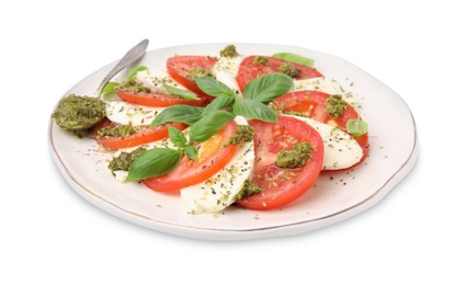 Photo of Plate of delicious Caprese salad and spoon with pesto sauce isolated on white