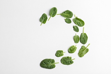 Photo of Frame made of spinach leaves on white background, top view. Space for text