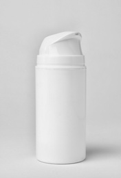 Photo of Bottle of cosmetic product on light background