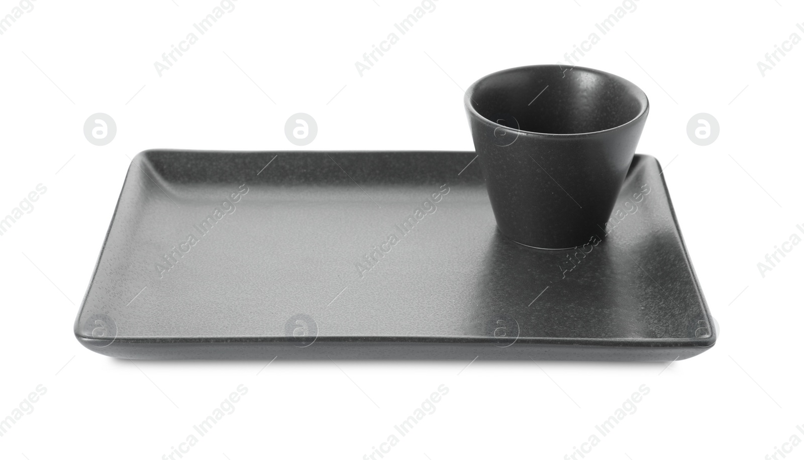 Photo of New black sauce dish and serving plate on white background