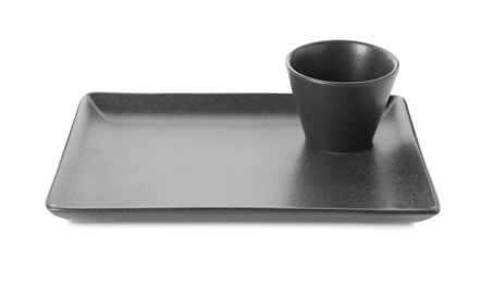 New black sauce dish and serving plate on white background