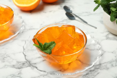 Orange jelly in bowl on marble table