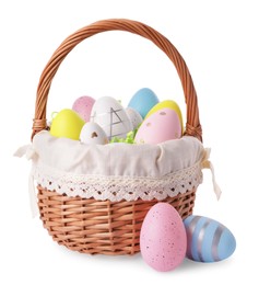 Photo of Wicker basket with beautifully painted Easter eggs isolated on white