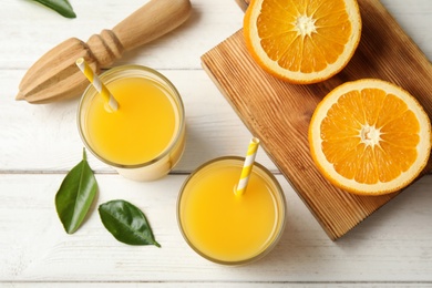 Photo of Flat lay composition with fresh orange juice on wooden background