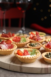 Delicious canapes with jamon and pate on grey table, closeup