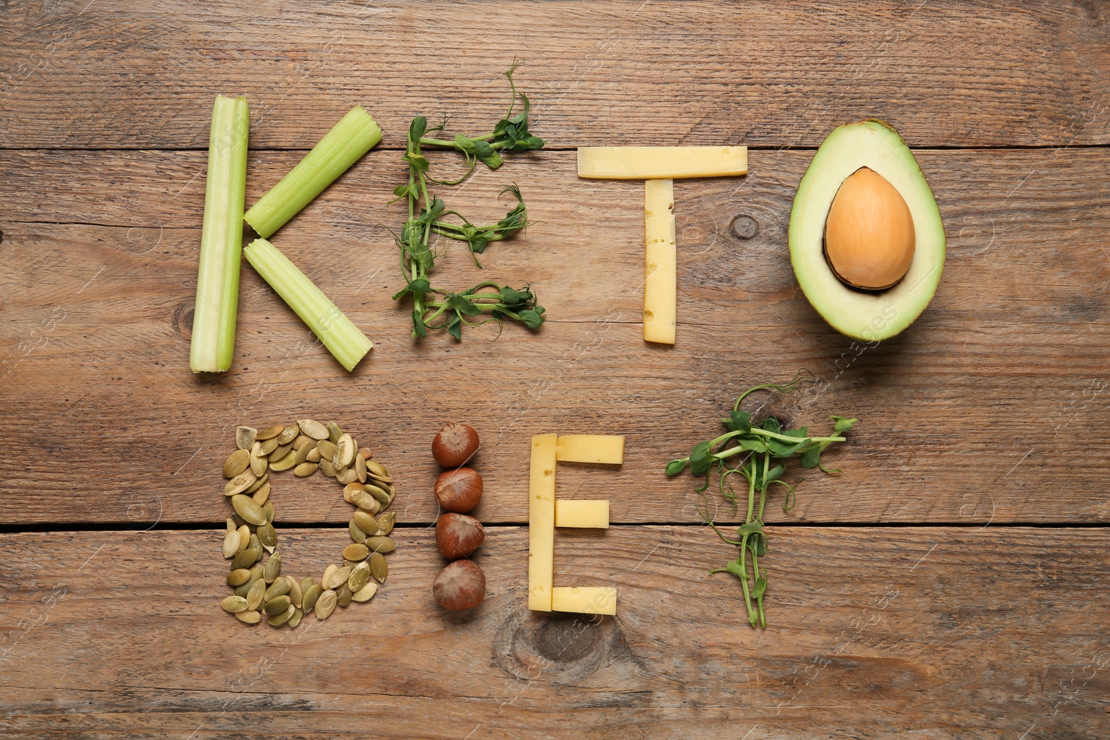 Photo of Phrase Keto Diet made with different products on wooden table, flat lay