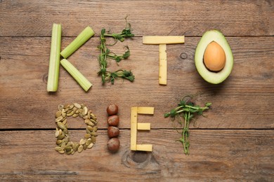 Photo of Phrase Keto Diet made with different products on wooden table, flat lay