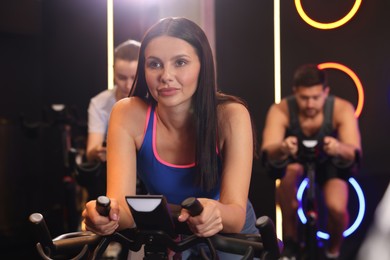 Photo of Group of people training on exercise bikes in fitness club