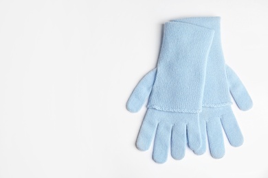 Photo of Stylish blue gloves on white background, top view with space for text. Autumn clothes