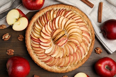 Flat lay composition with delicious homemade apple tart on wooden table