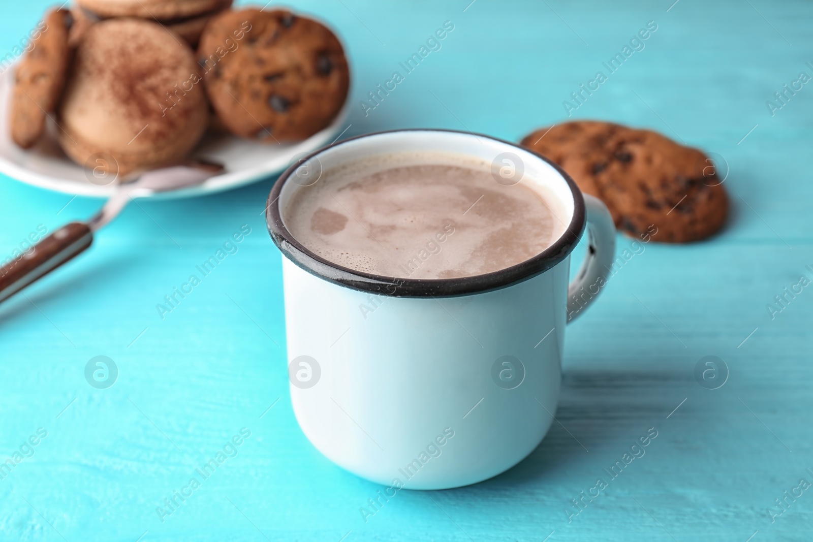 Photo of Mug with delicious hot cocoa drink on wooden table