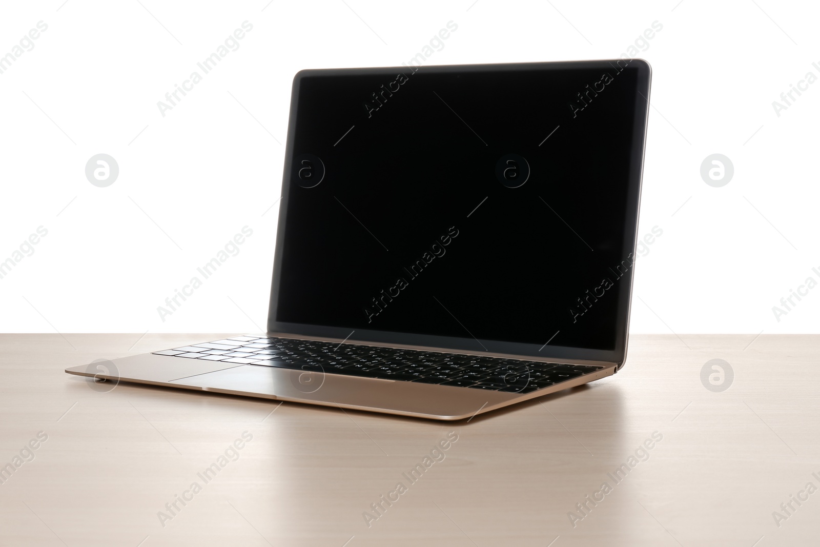 Photo of Modern laptop with blank screen on table against white background