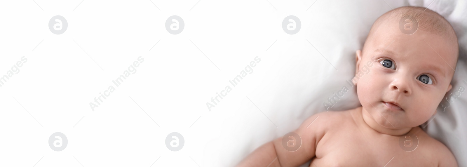 Image of Cute little baby lying on bed, top view with space for text. Banner design