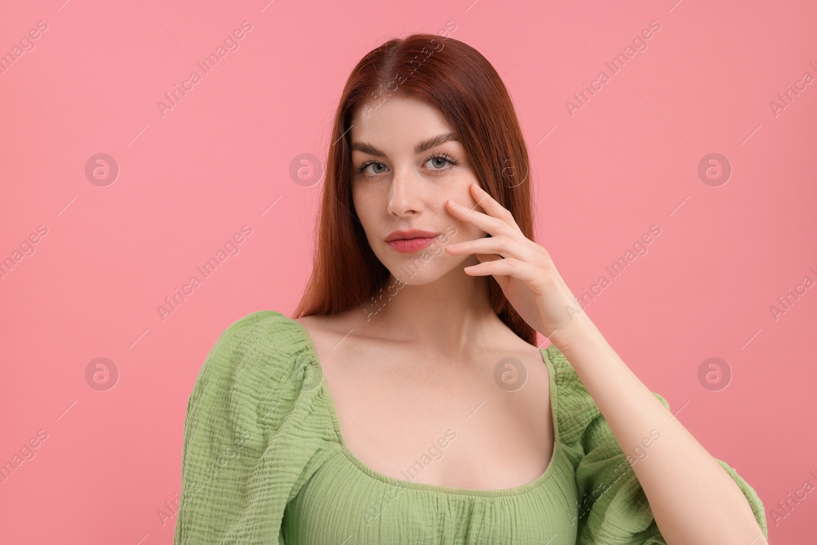 Photo of Portrait of beautiful woman with freckles on pink background